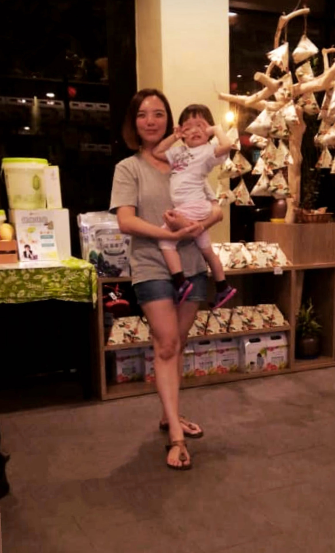 Vion Lee carrying her young daughter